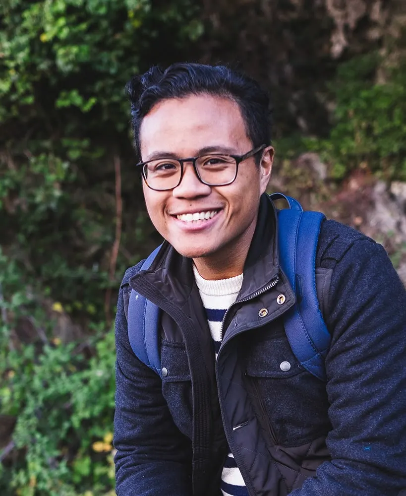 Angelito Jusay, New York City wedding photographer, smiling outdoors