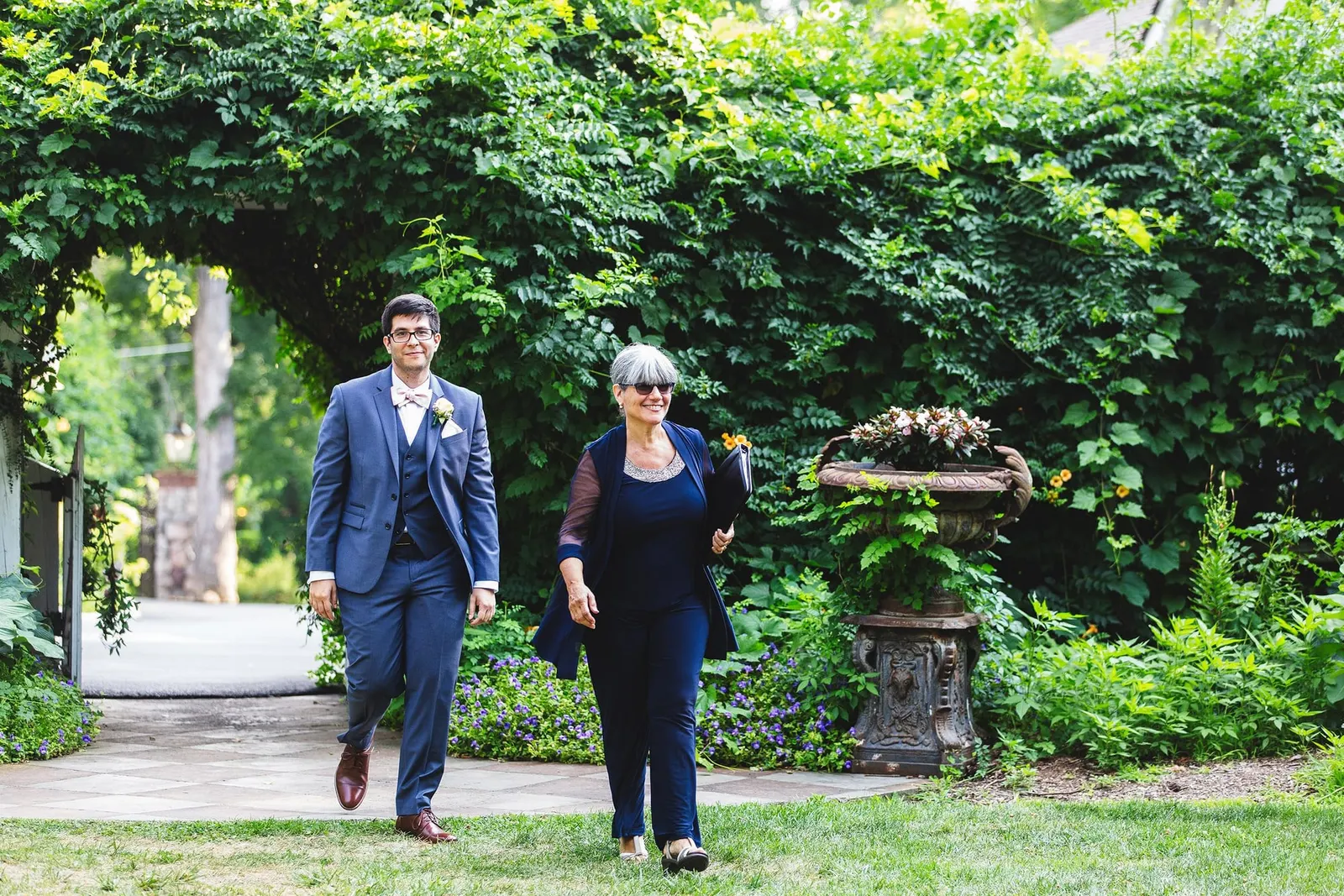 Processional through an ivy-covered garden arch