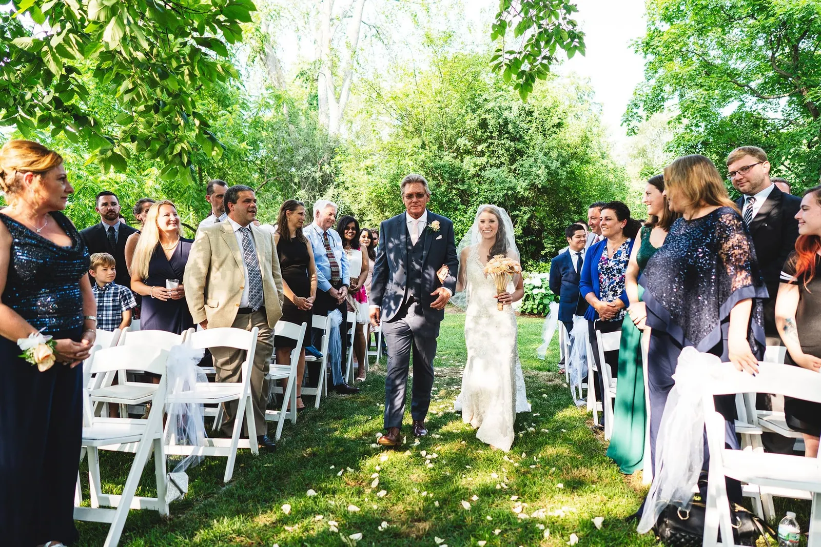 Bride walking down the aisle between rows of guests