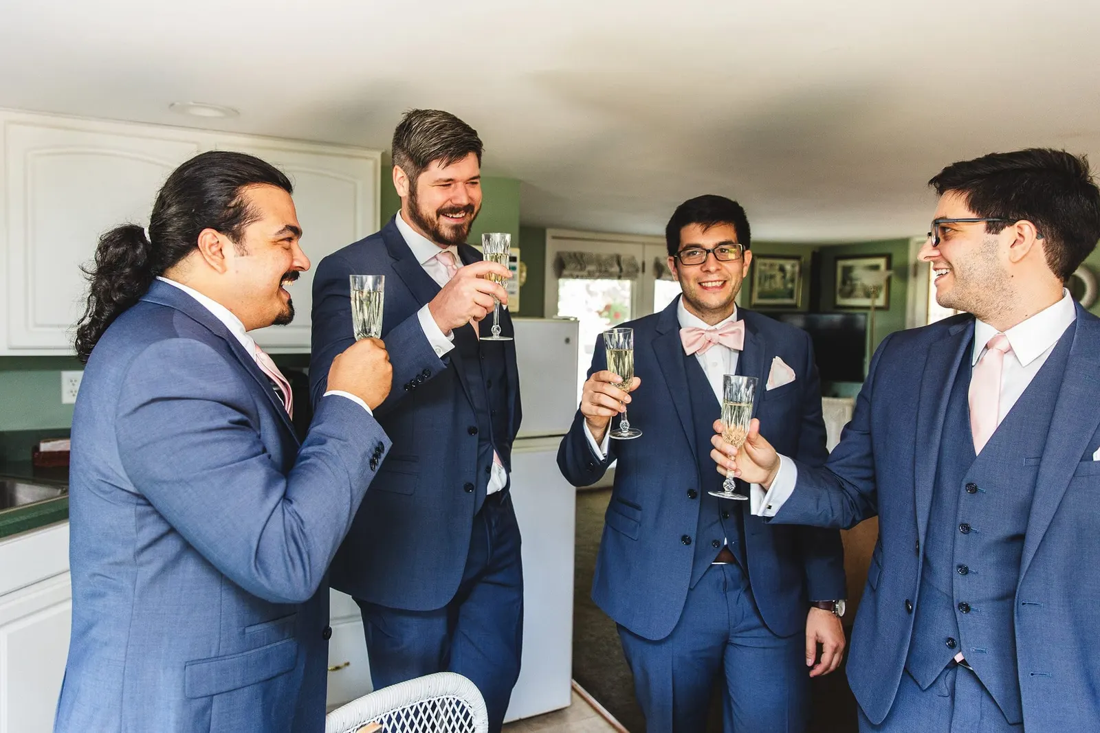 Groom and groomsmen toasting with champagne before the wedding