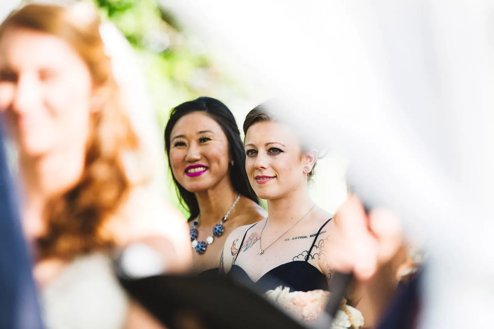 Bridesmaids smiling during the vows
