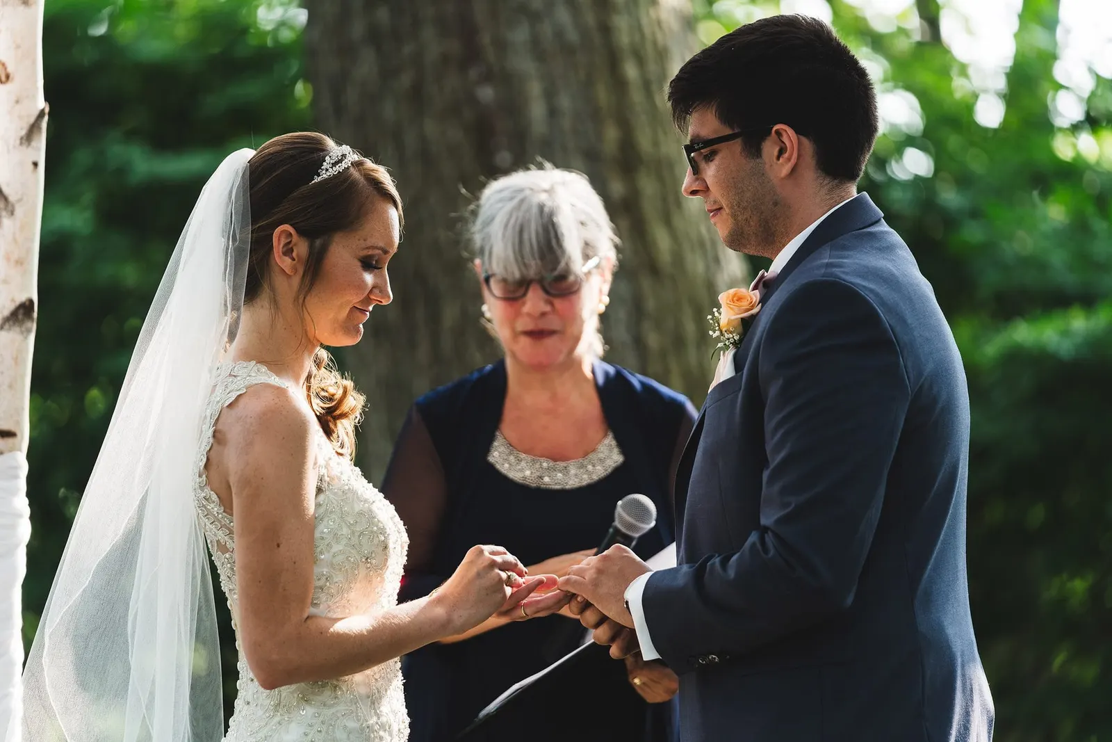Bride placing the ring on the groom's finger