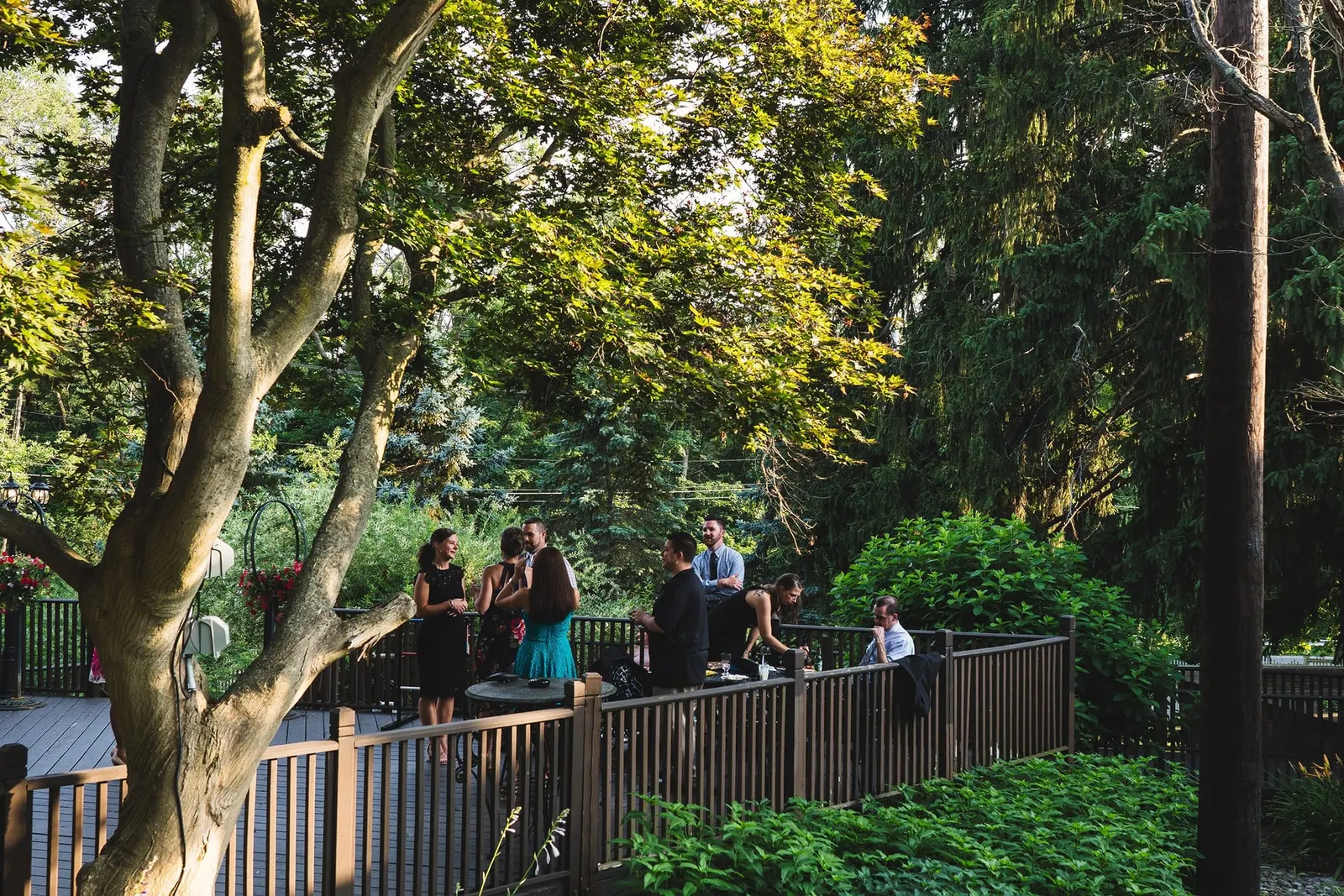 Guests mingling on the garden deck during cocktail hour