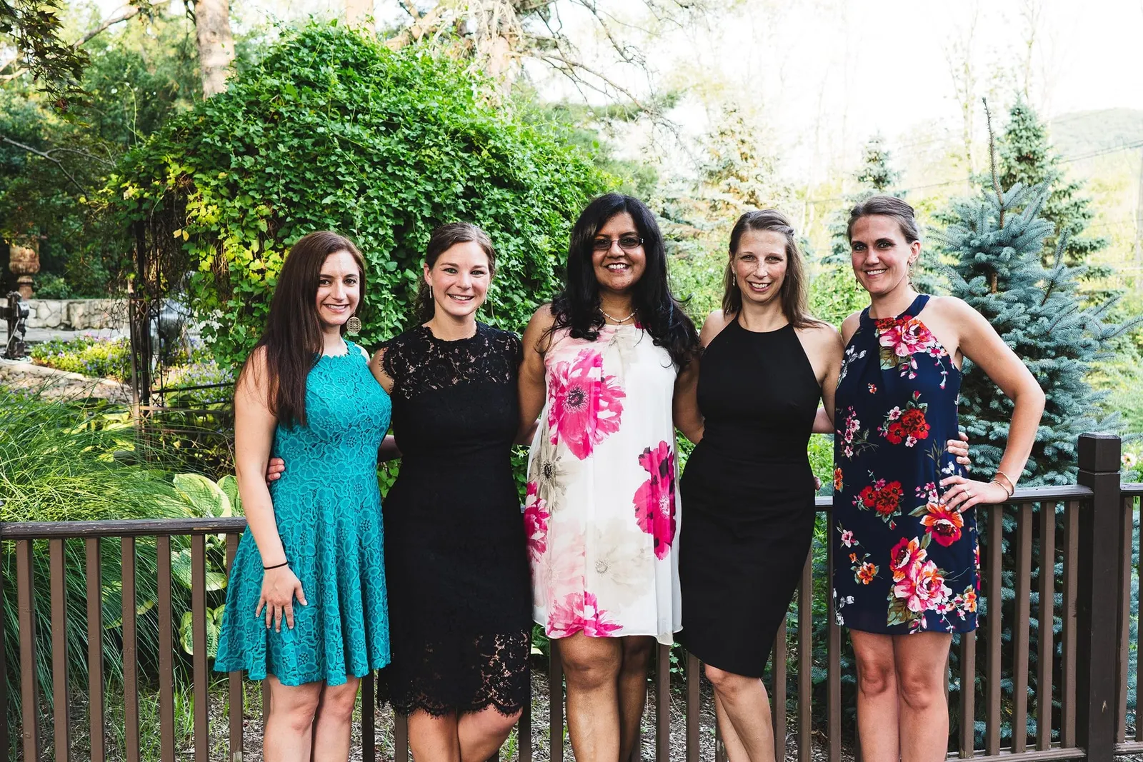 Friends posing together on the deck during cocktail hour
