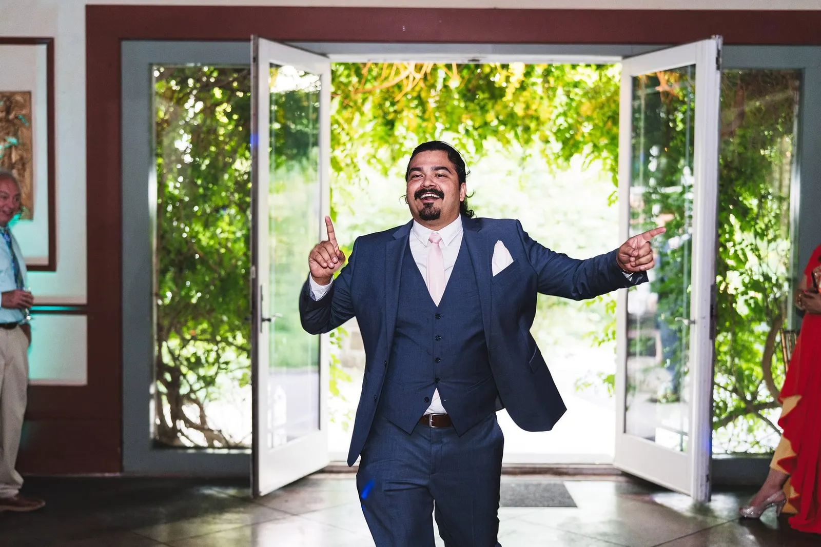 Groom making a grand entrance through the French doors