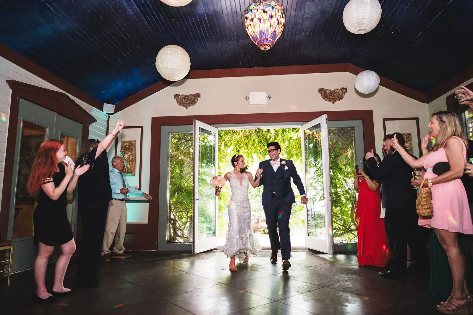 Newlyweds entering the reception through the French doors