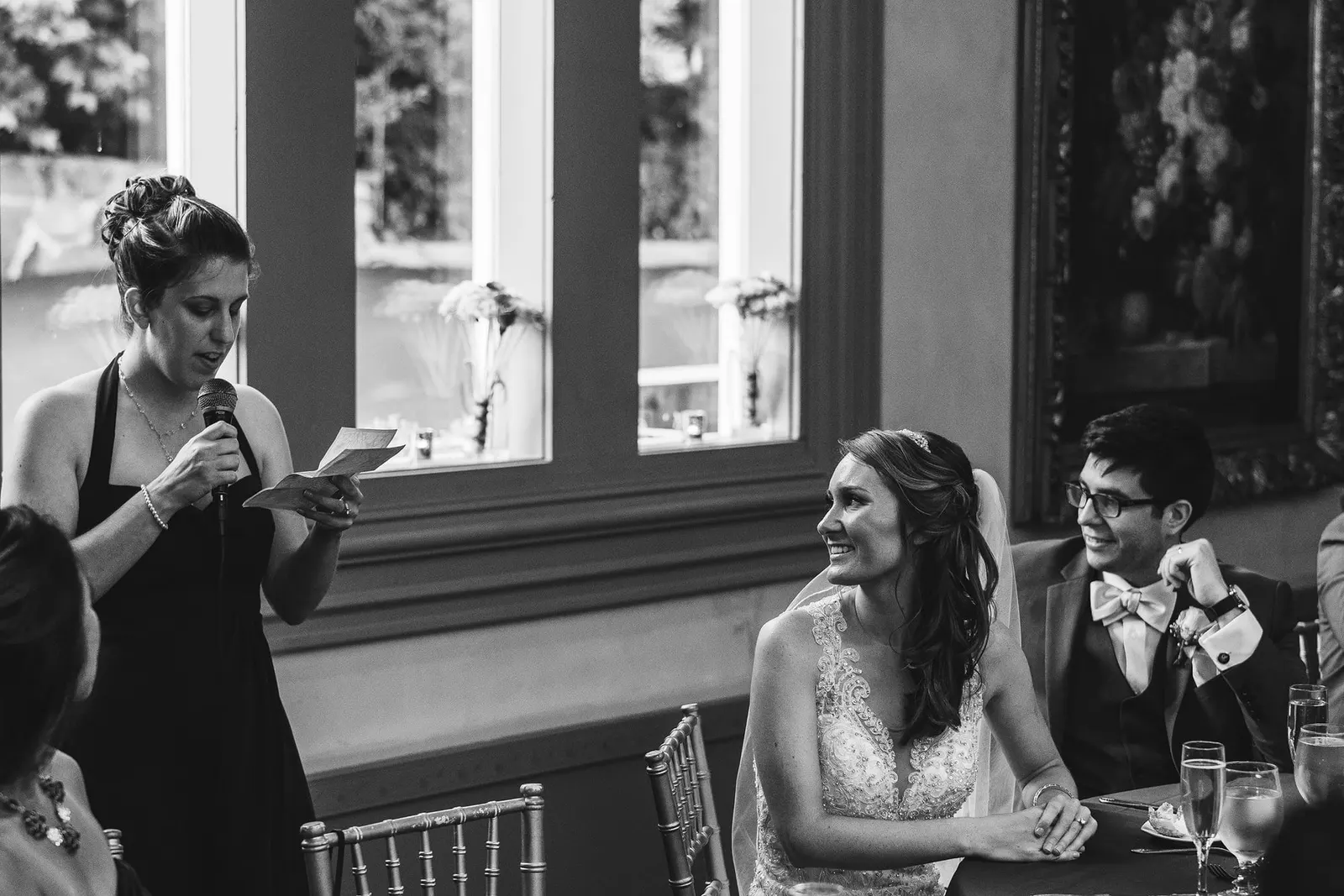 Black and white photo of a toast to the newlyweds