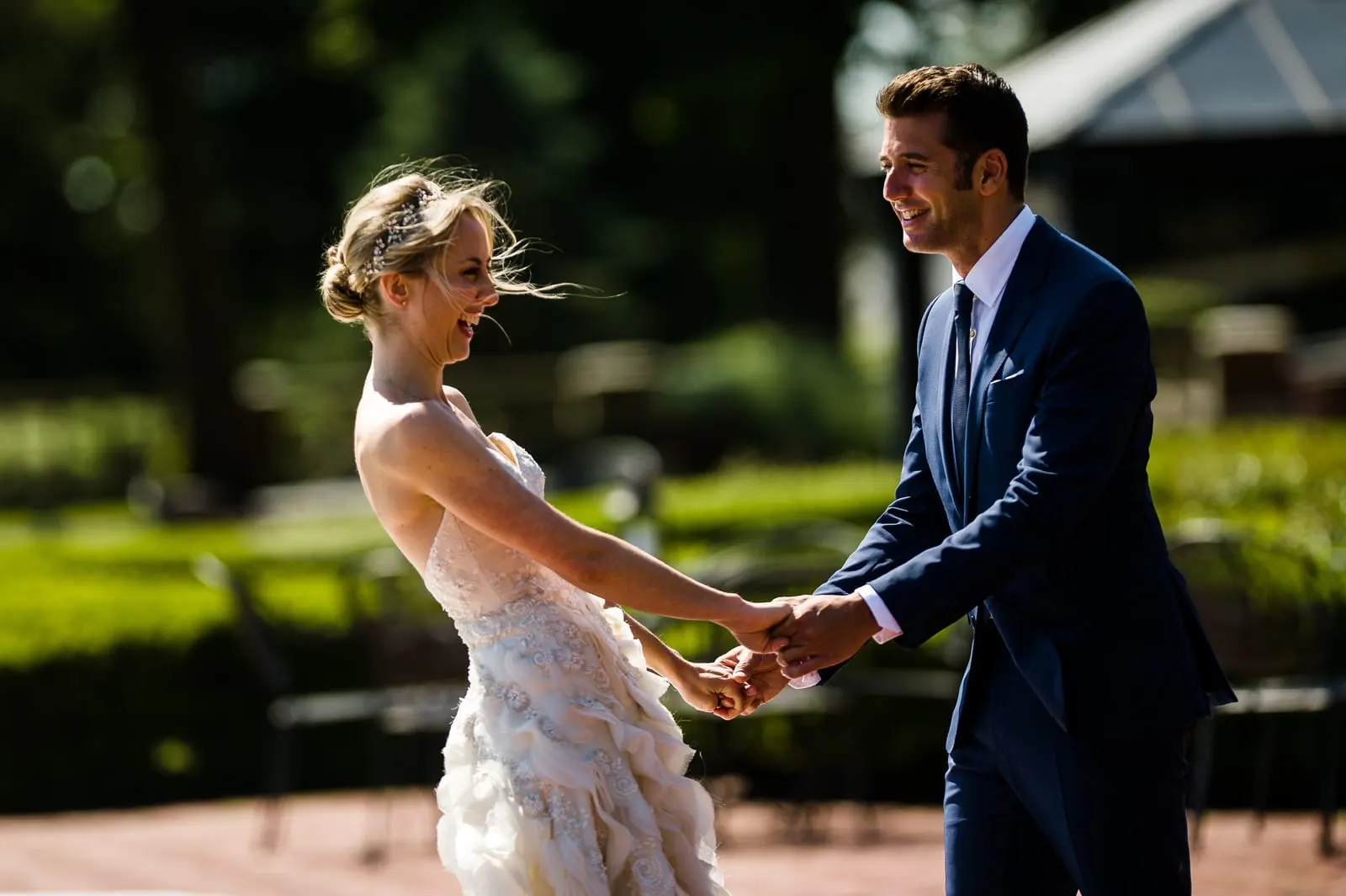 Groom holding the bride's hands in the garden at Bourne Mansion