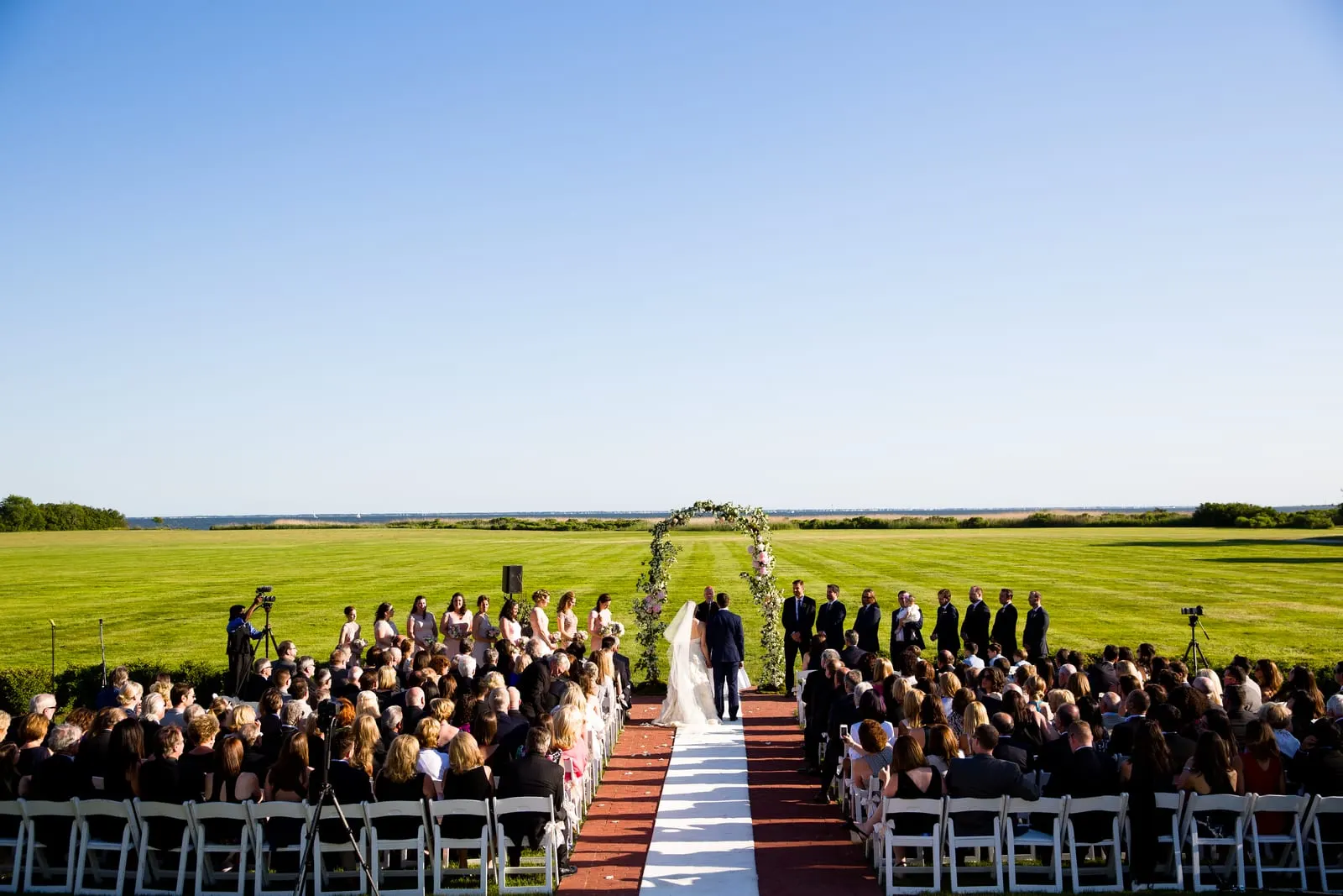 Guests gathered on the great lawn for the ceremony under a clear blue sky