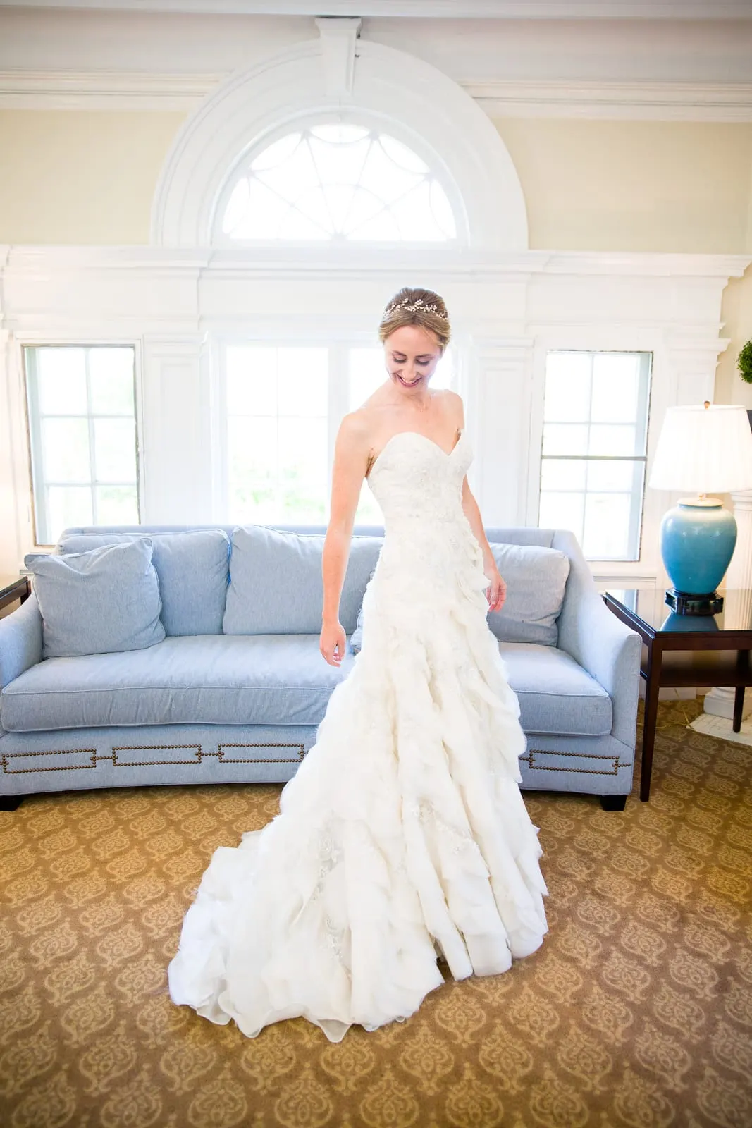 Bride in her gown in the sunlit bridal suite
