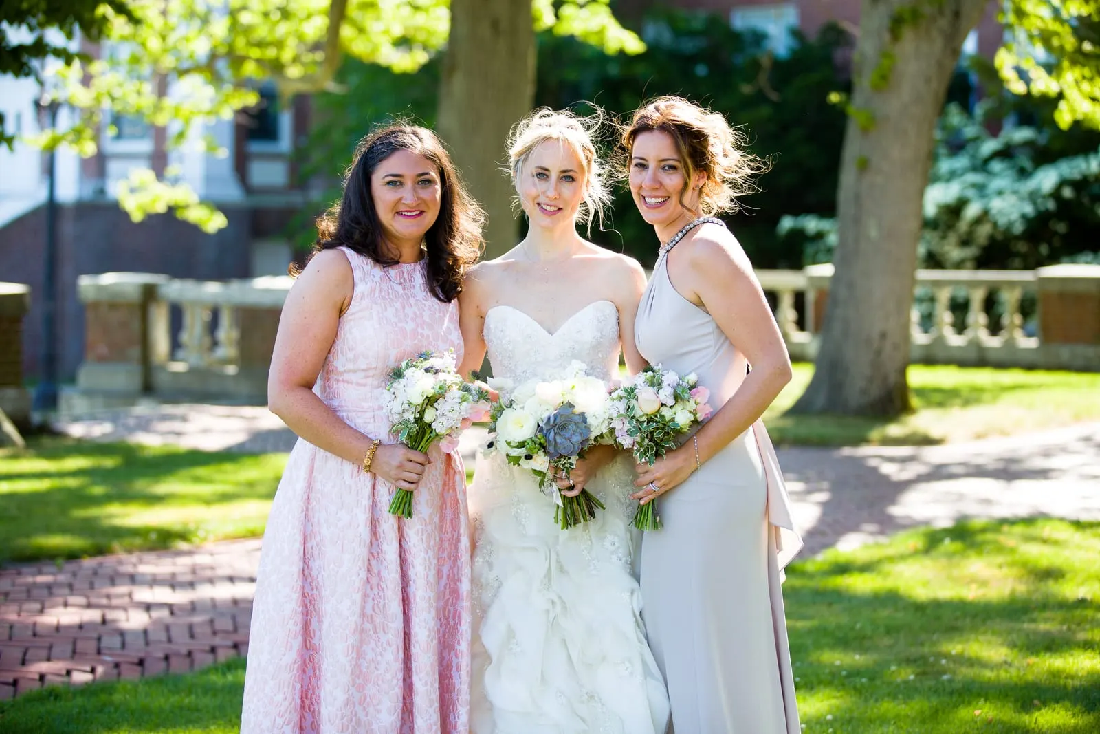 Bride with two bridesmaids holding white bouquets