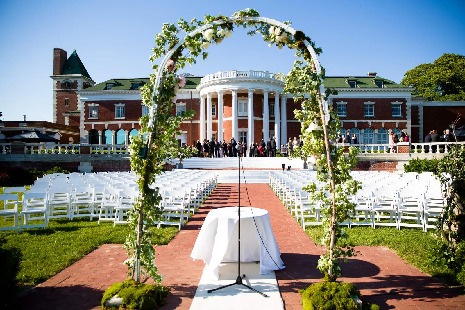 Floral ceremony arch with the mansion in the background