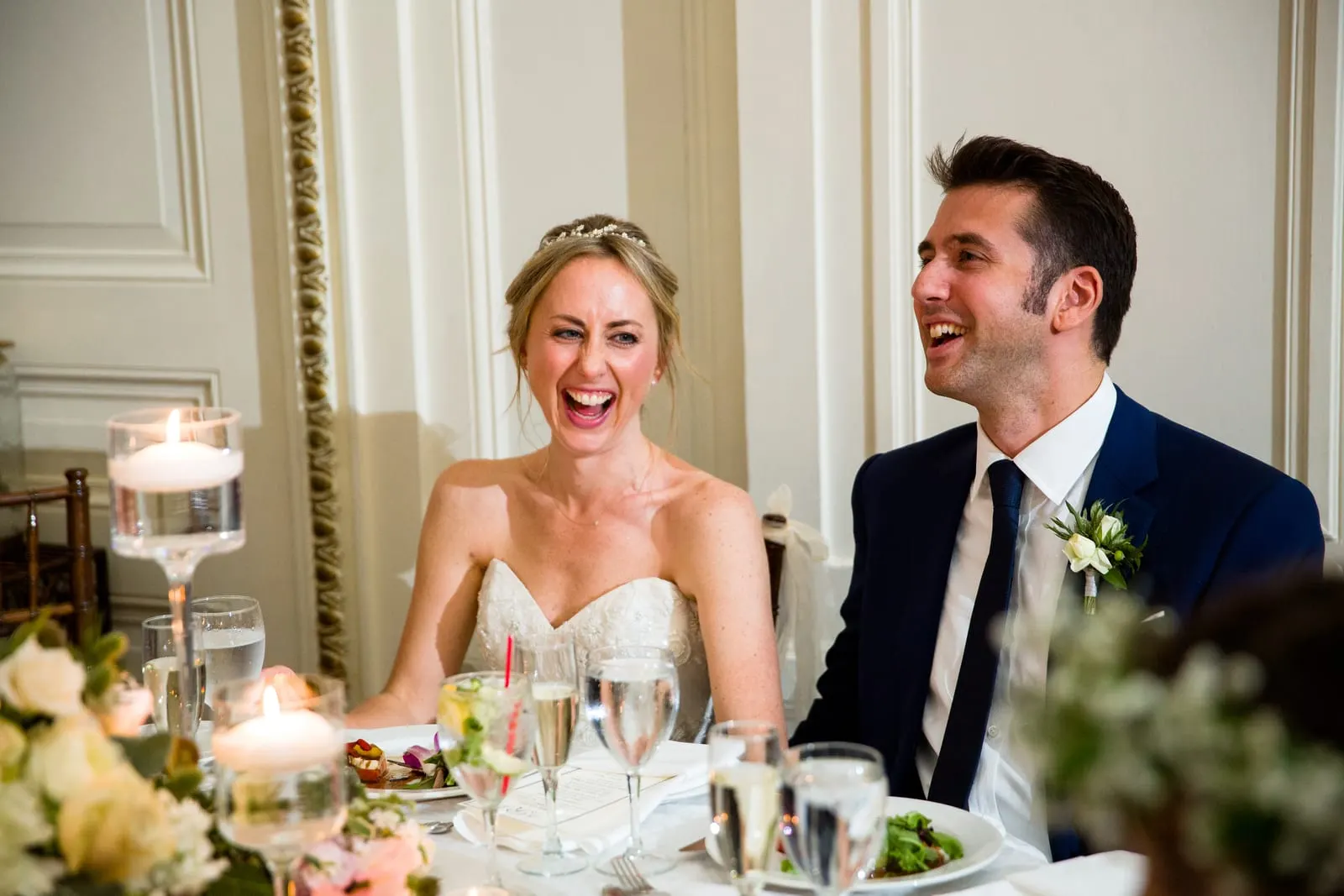 Bride and groom laughing during the toasts
