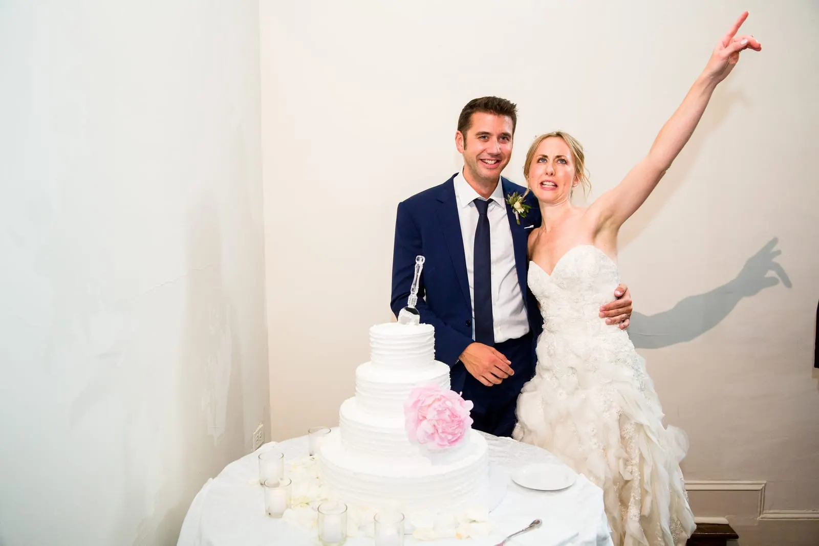 Bride celebrating after cutting the wedding cake