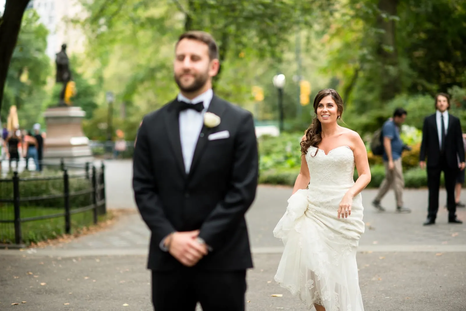 Bride walking up behind the groom for their first look in Central Park