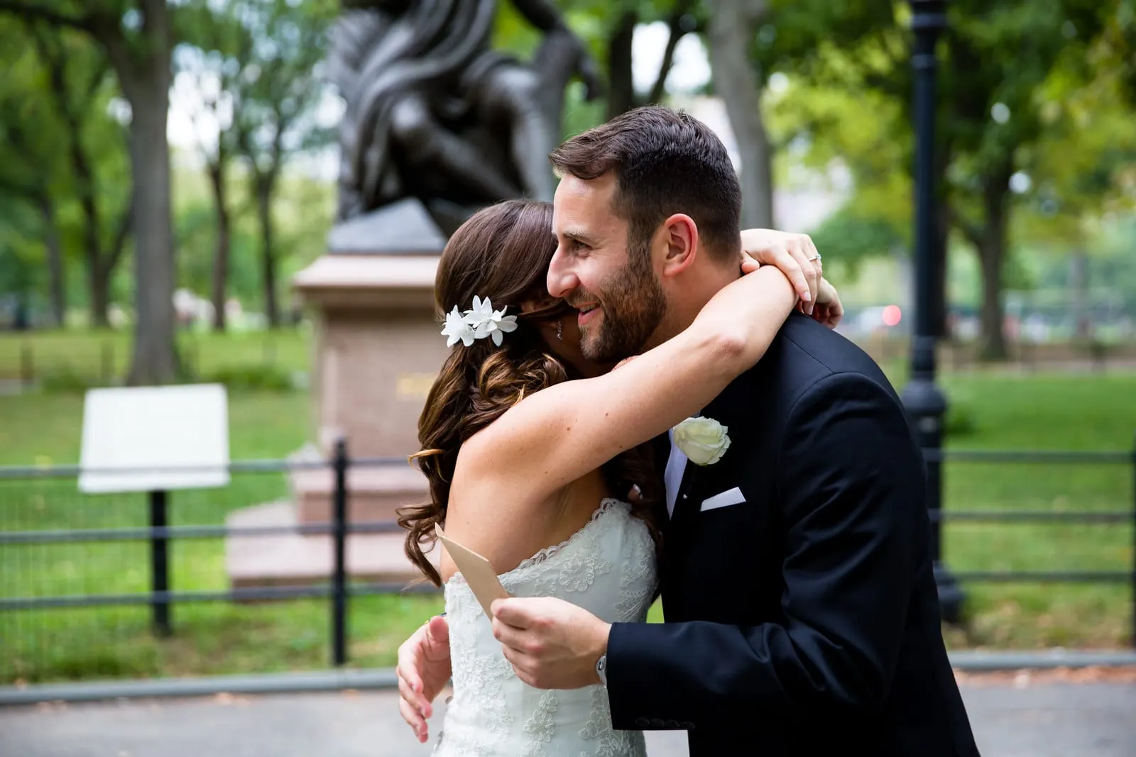 Bride and groom hugging after reading letters on the Literary Walk