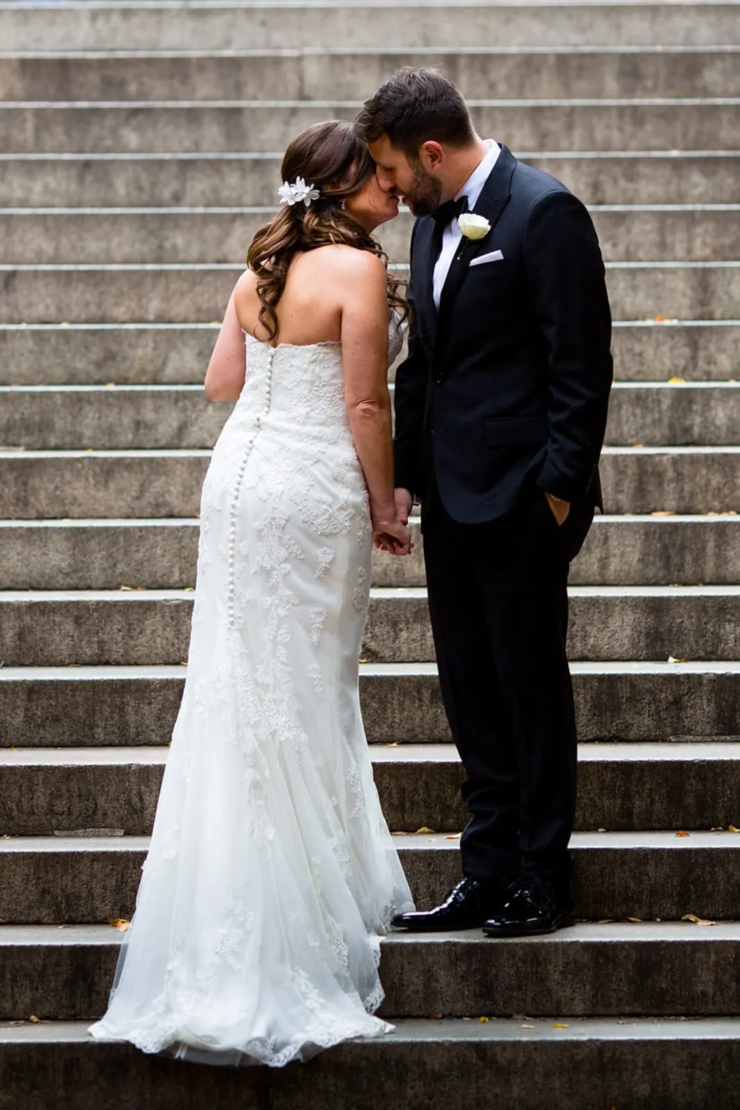 Bride and groom kissing on the stairs at Bethesda Terrace