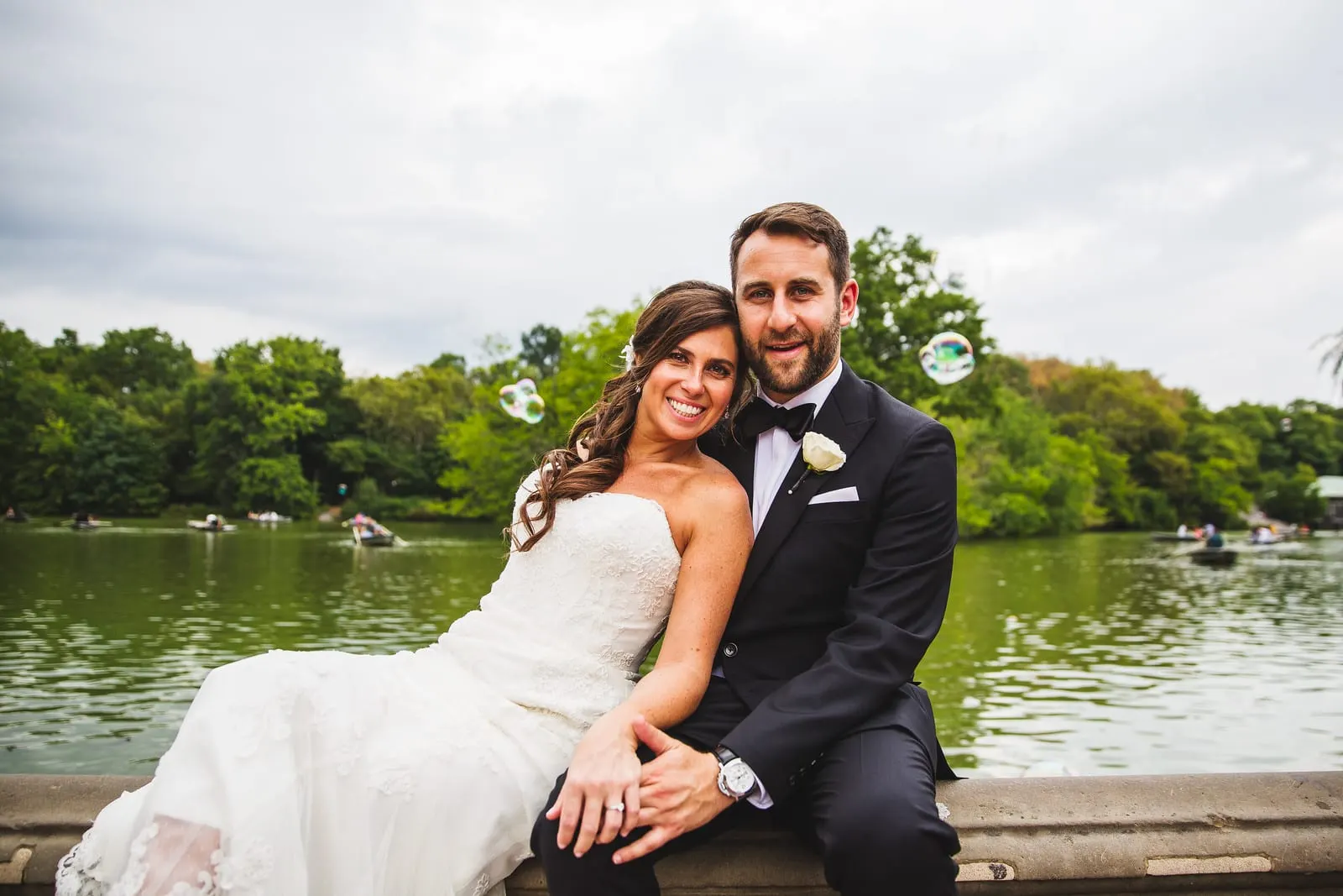 Bride and groom leaning together by the Lake in Central Park