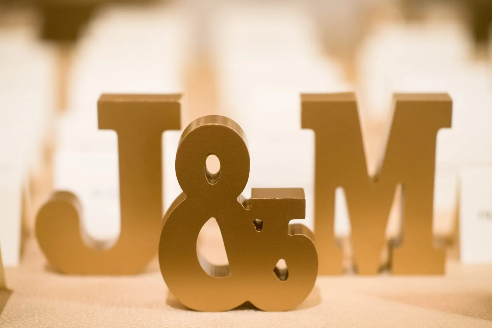 Gold J&M letters on the escort card table