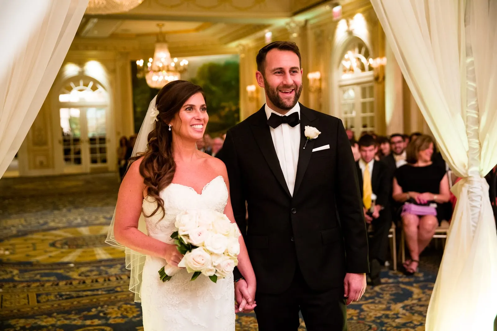 Bride and groom smiling under the chuppah