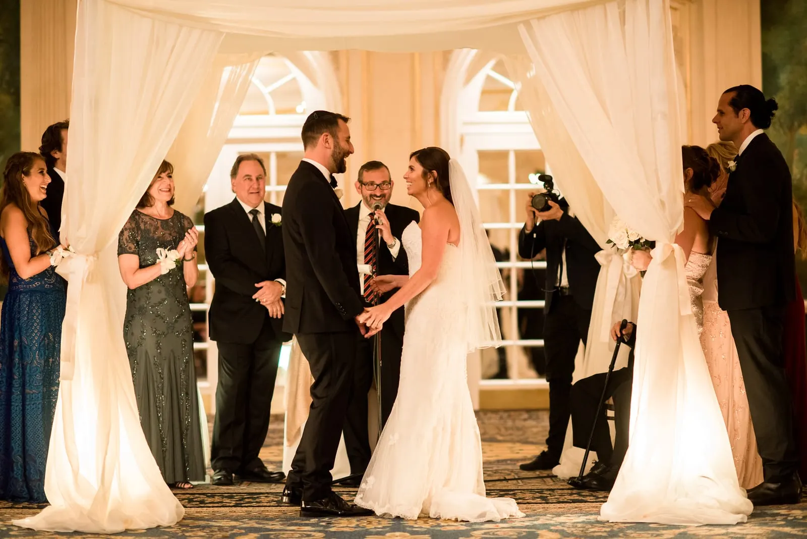 Bride and groom under the chuppah in the ballroom