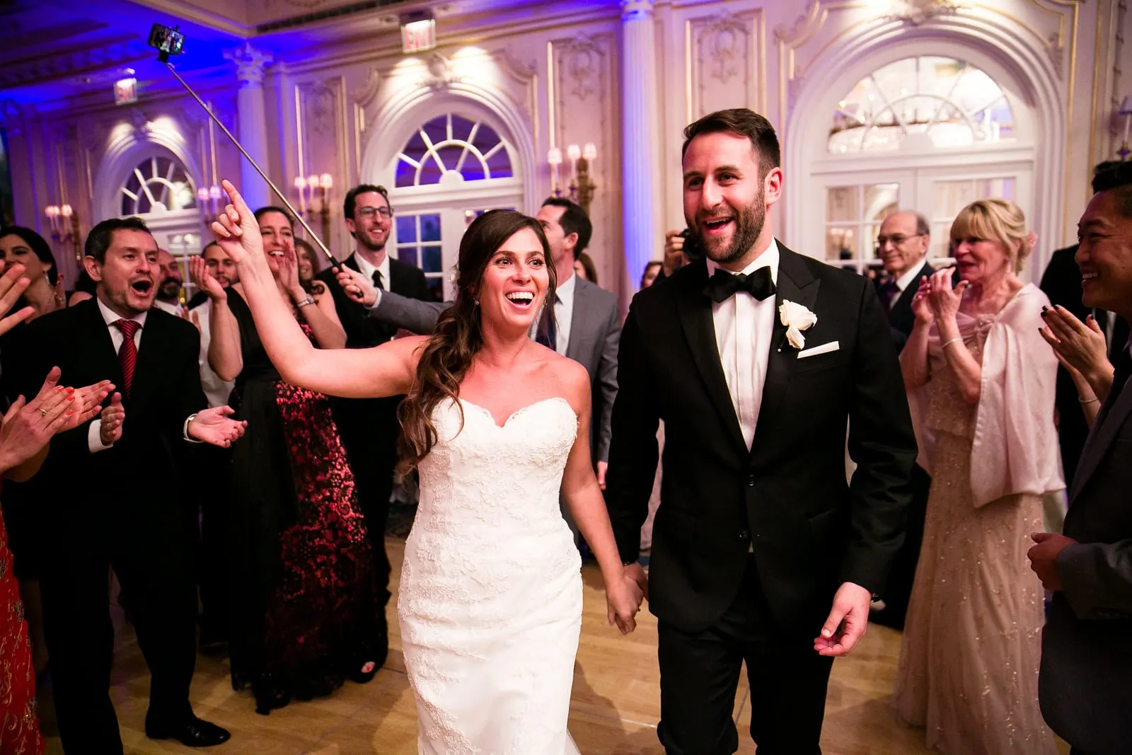 Bride and groom dancing into the ballroom for their grand entrance