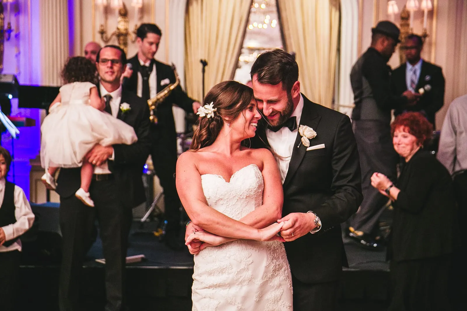 Bride and groom laughing together on the dance floor