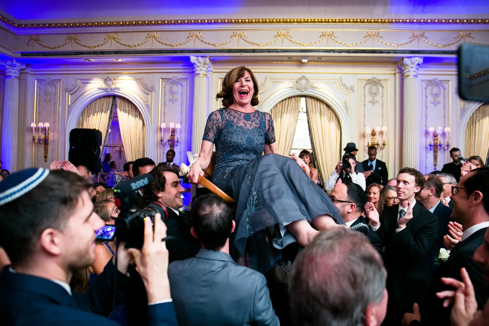 One of the mothers lifted on a chair during the hora