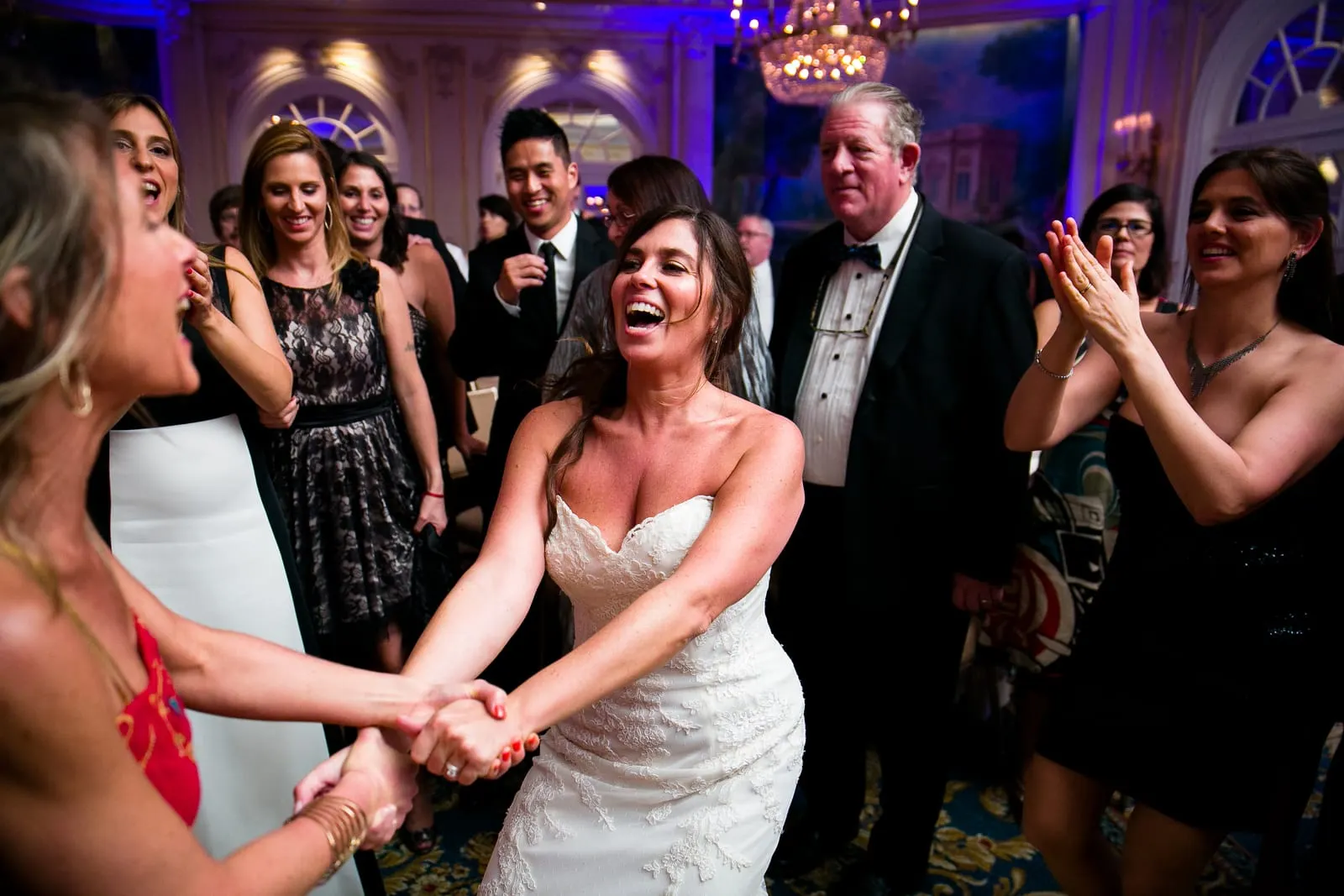 Bride dancing hand in hand with a friend