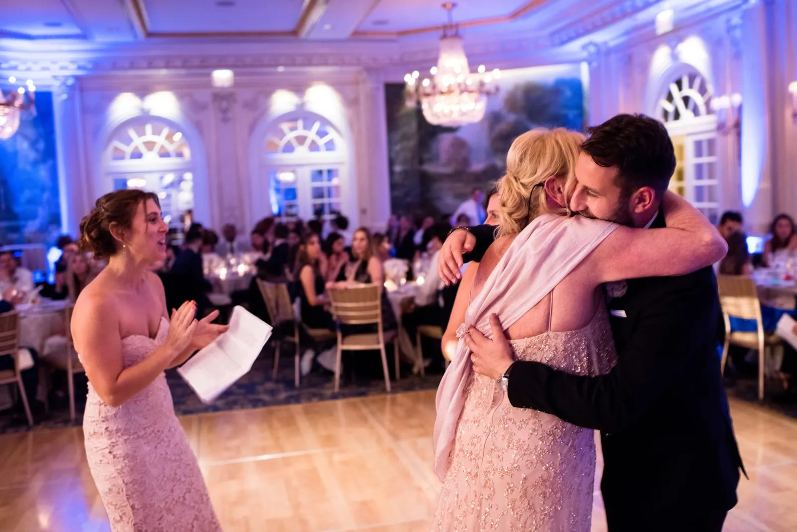 Groom hugging a guest after her toast