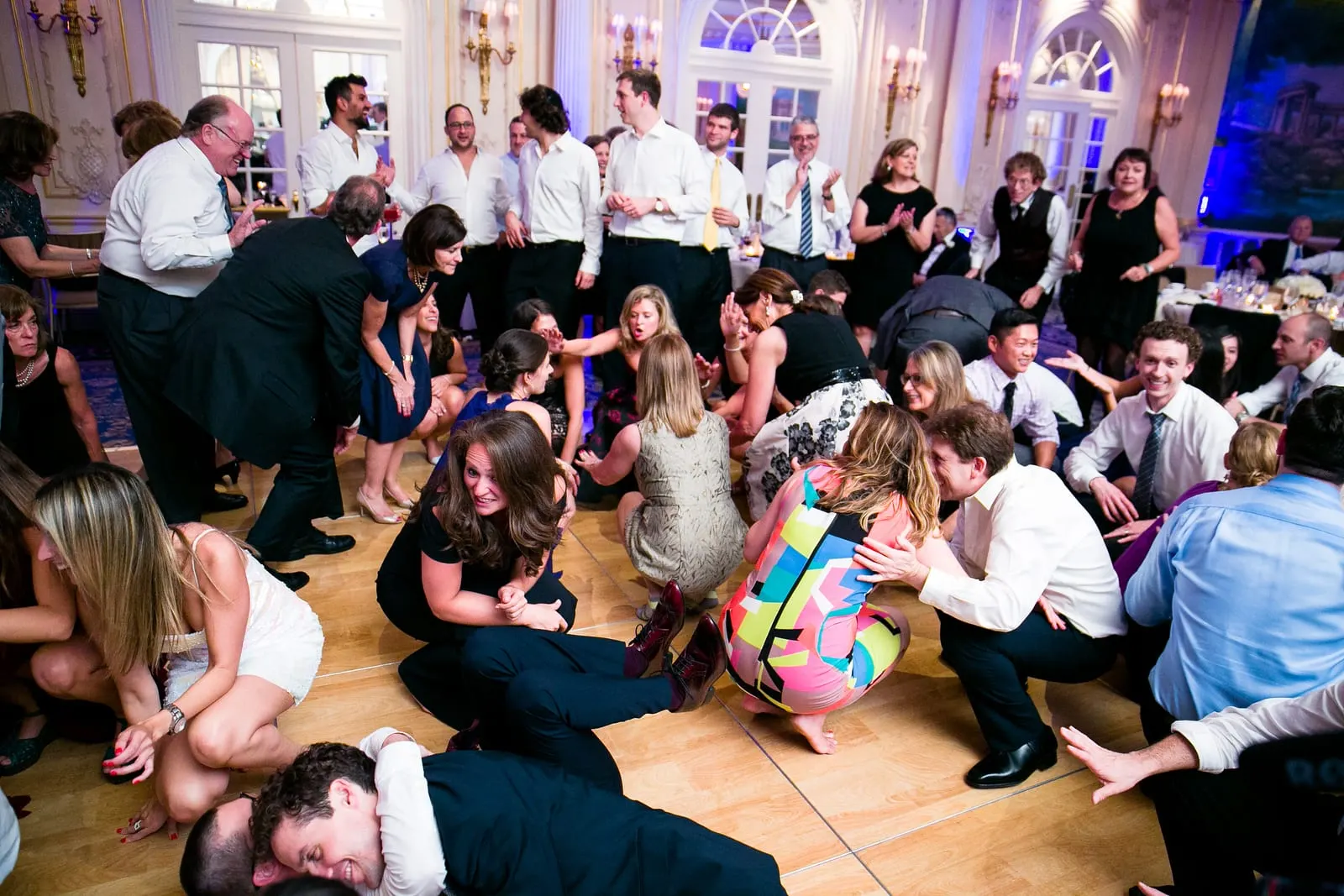 Guests crouching low on the dance floor