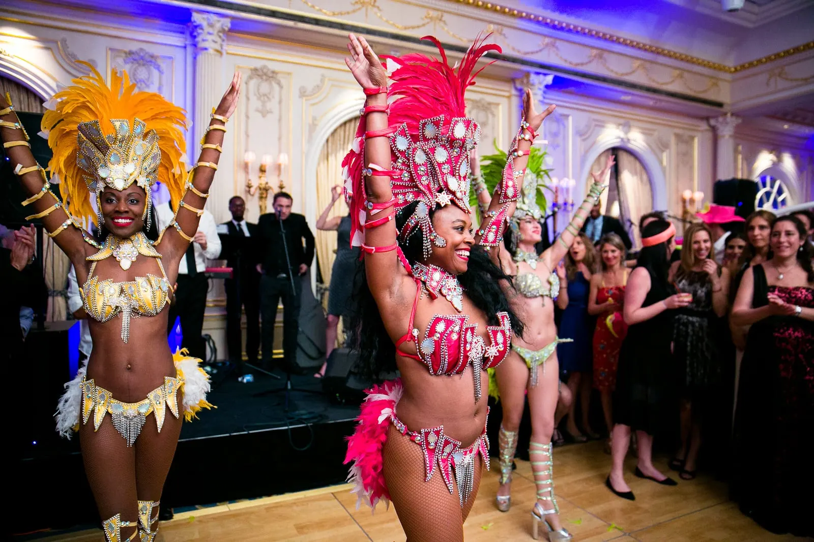 Samba dancers in feathered headdresses performing in the ballroom