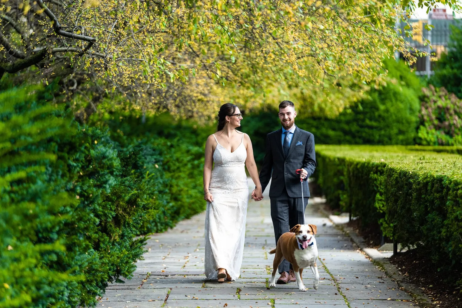 Bride and groom with their dog in the Conservatory Garden, Central Park