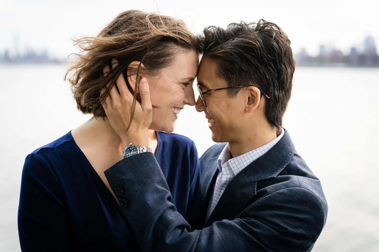Close-up of the couple touching foreheads by the East River