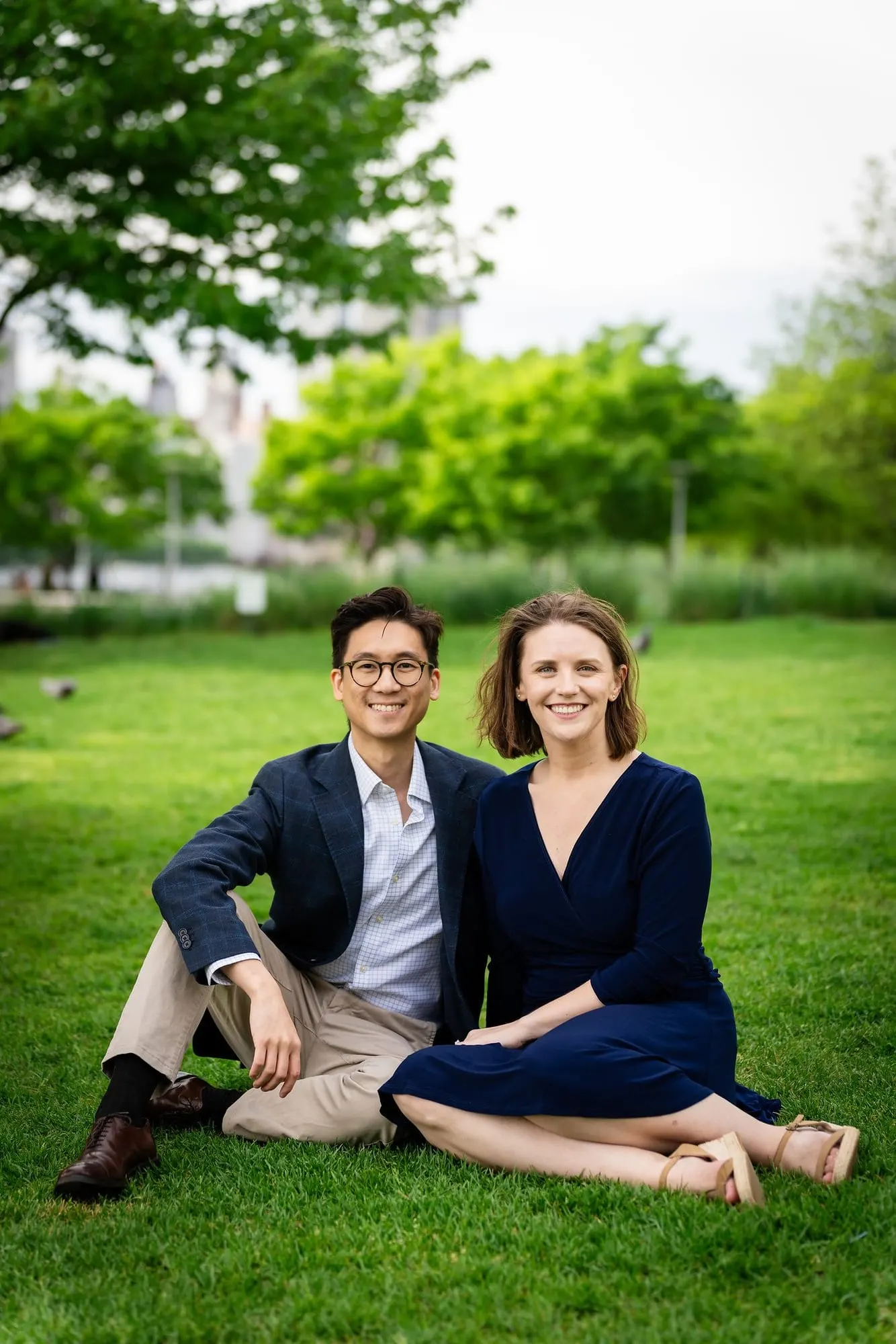 Couple sitting together on the lawn at Gantry Plaza State Park
