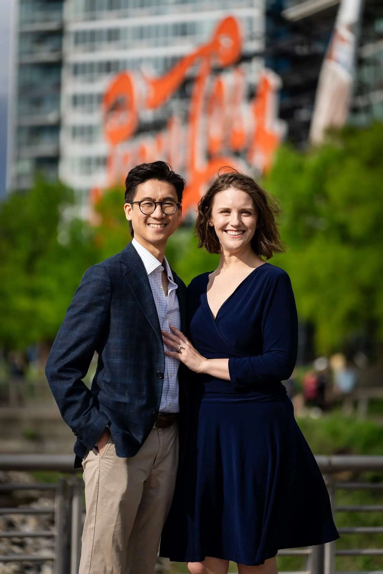 Couple posing in front of the Pepsi-Cola sign in Long Island City