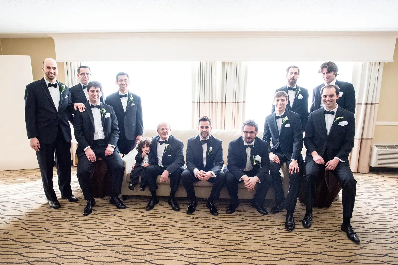 Groom with his groomsmen in black tuxedos