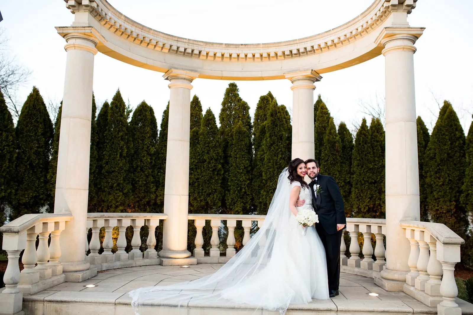 Bride and groom under the columned rotunda at Rockleigh Country Club