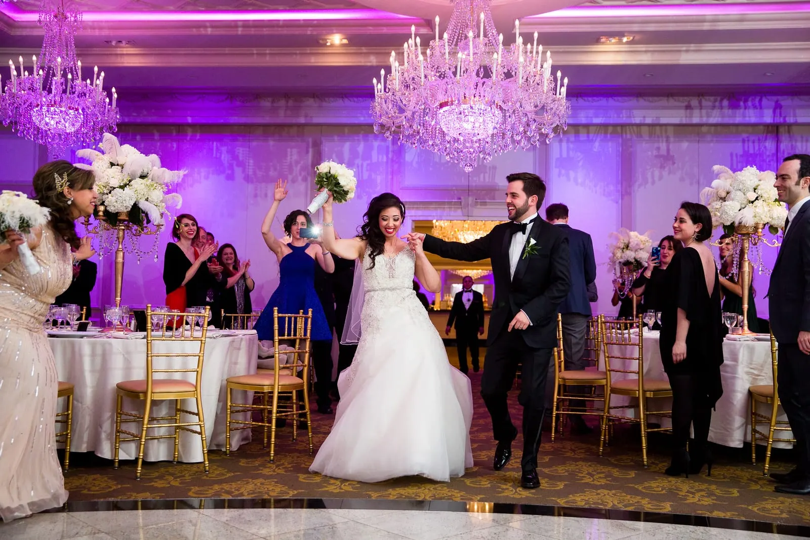 Bride and groom dancing into the ballroom for their grand entrance