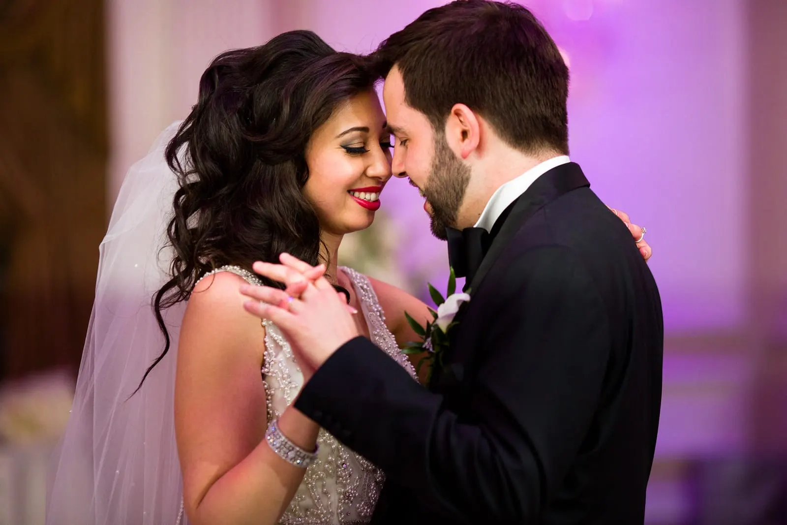 Bride and groom forehead to forehead during their first dance