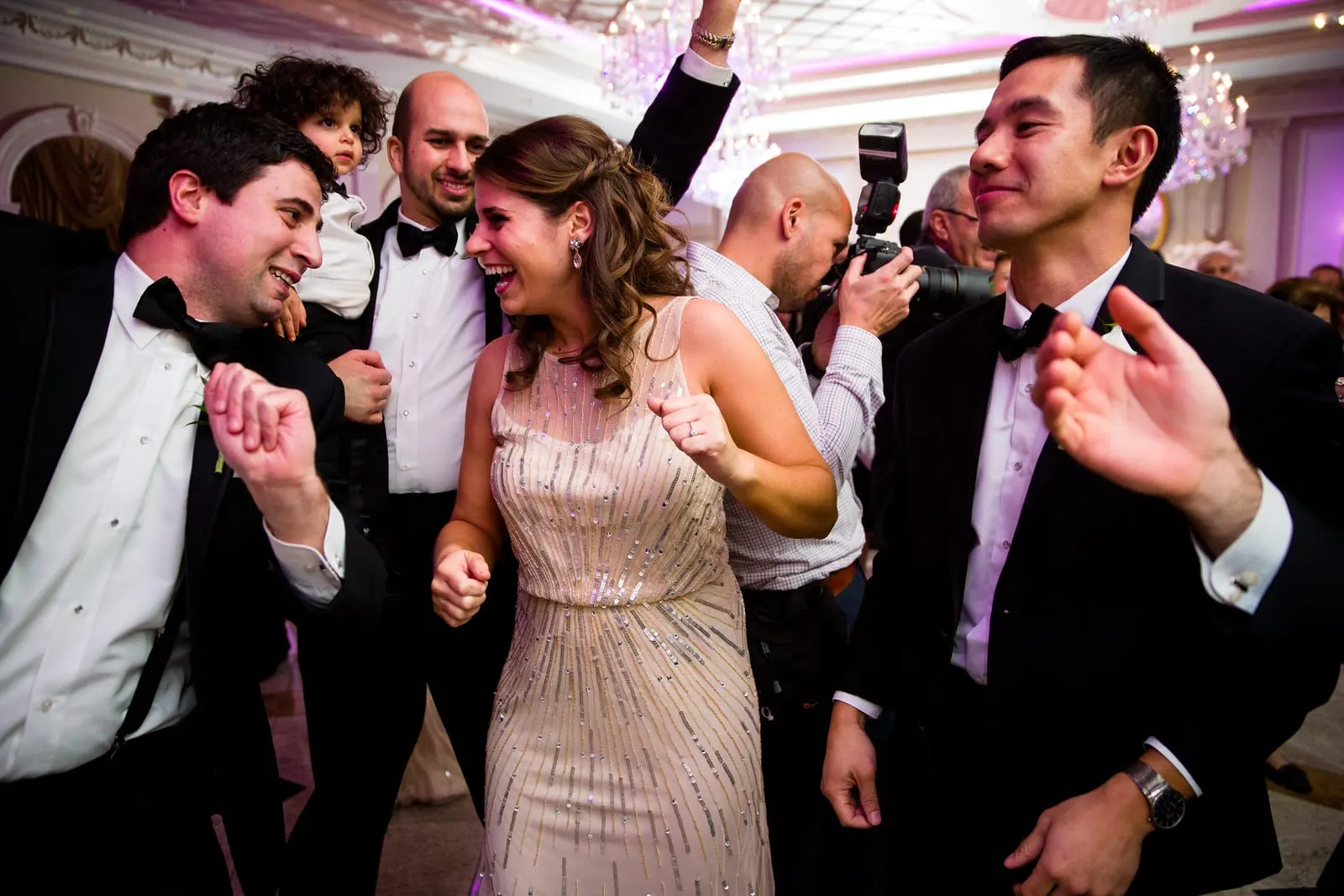 Groomsmen and bridesmaids celebrating on the dance floor