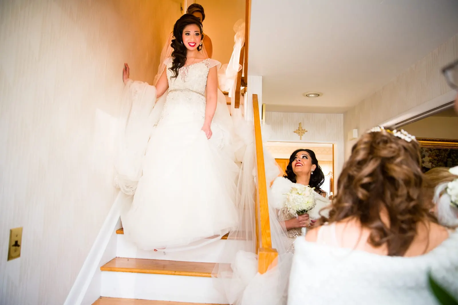 Bride walking down the stairs in her gown