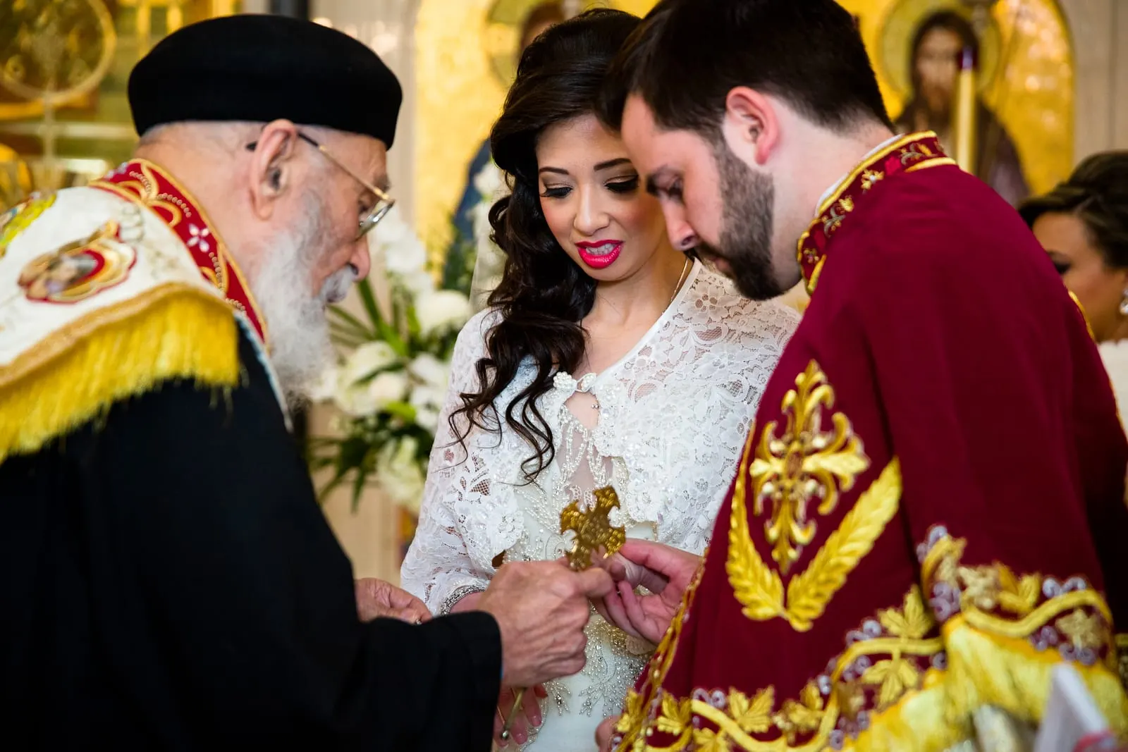 Priest blessing the rings during the ceremony