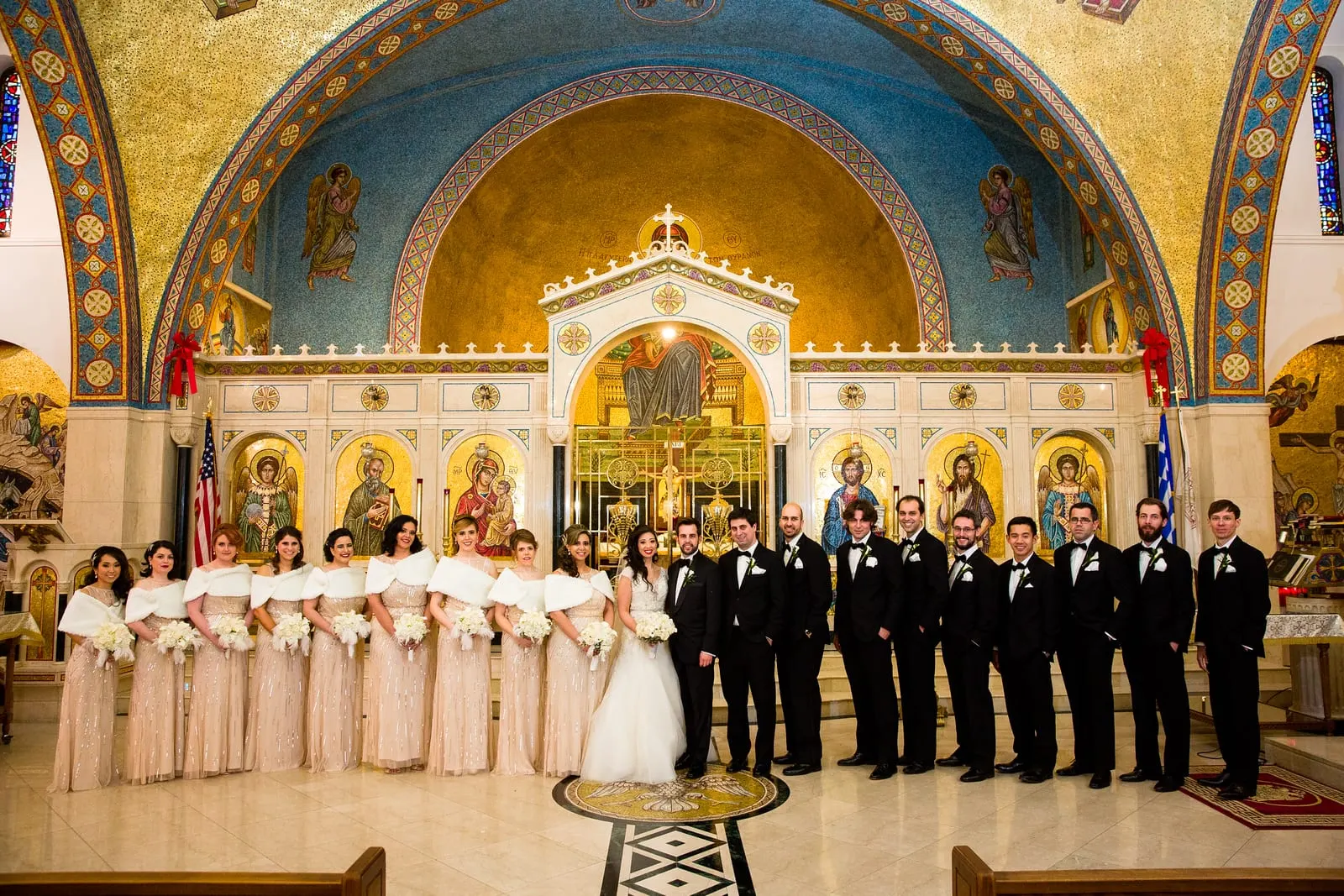 Full wedding party in front of the iconostasis
