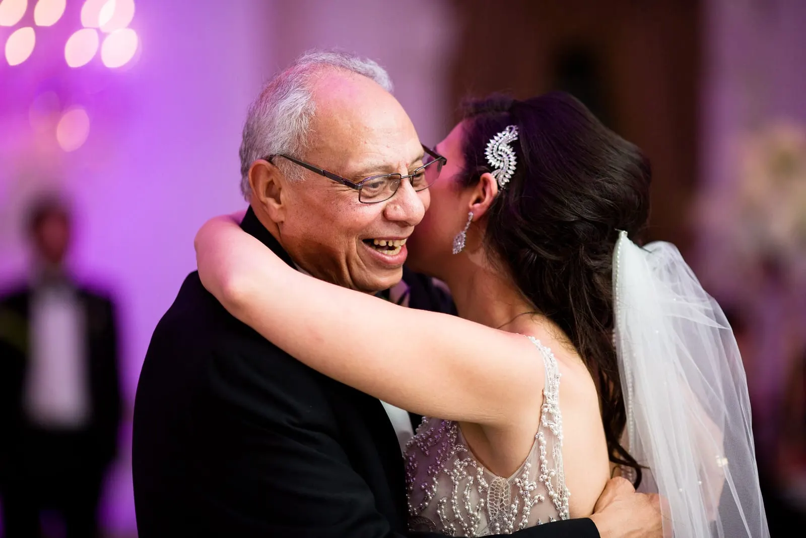 Bride hugging her father at the end of their dance