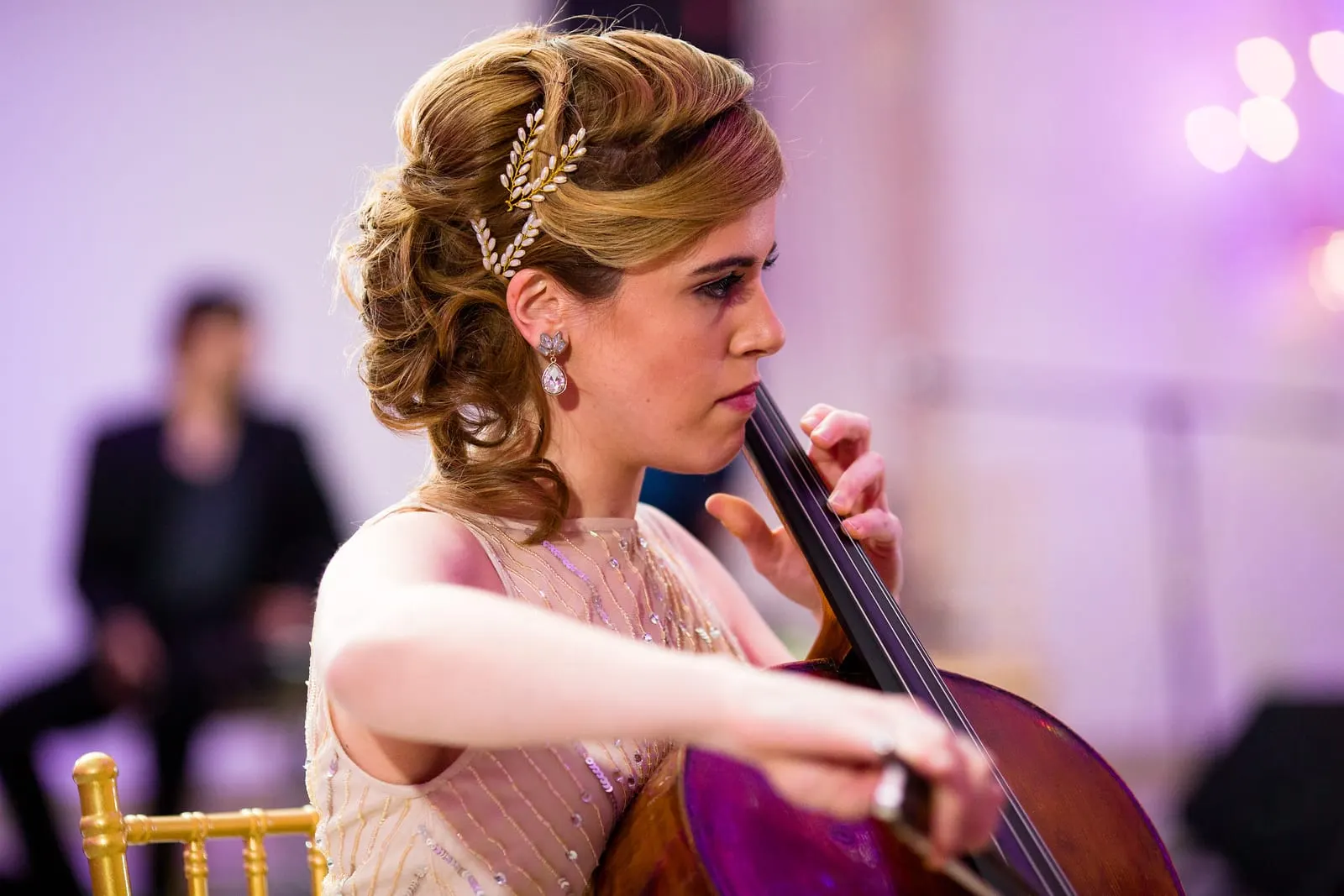 Bridesmaid playing cello for the couple