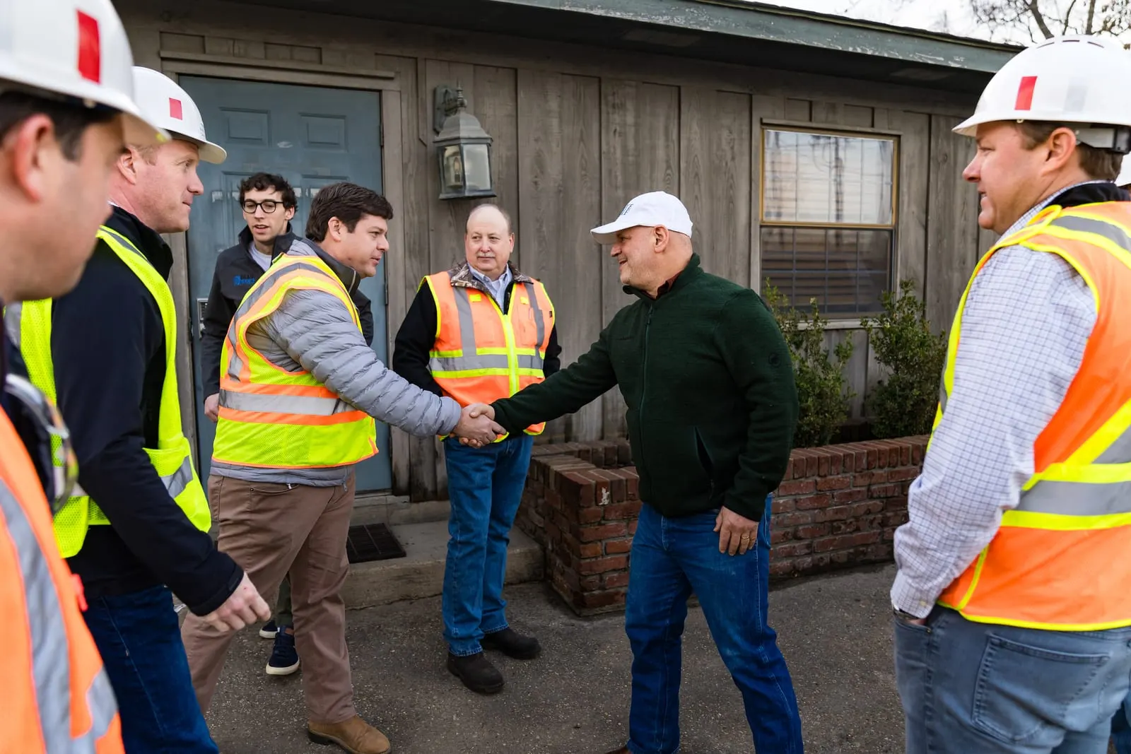Blue Wolf Capital visitors greeting the mill's leadership outside the office