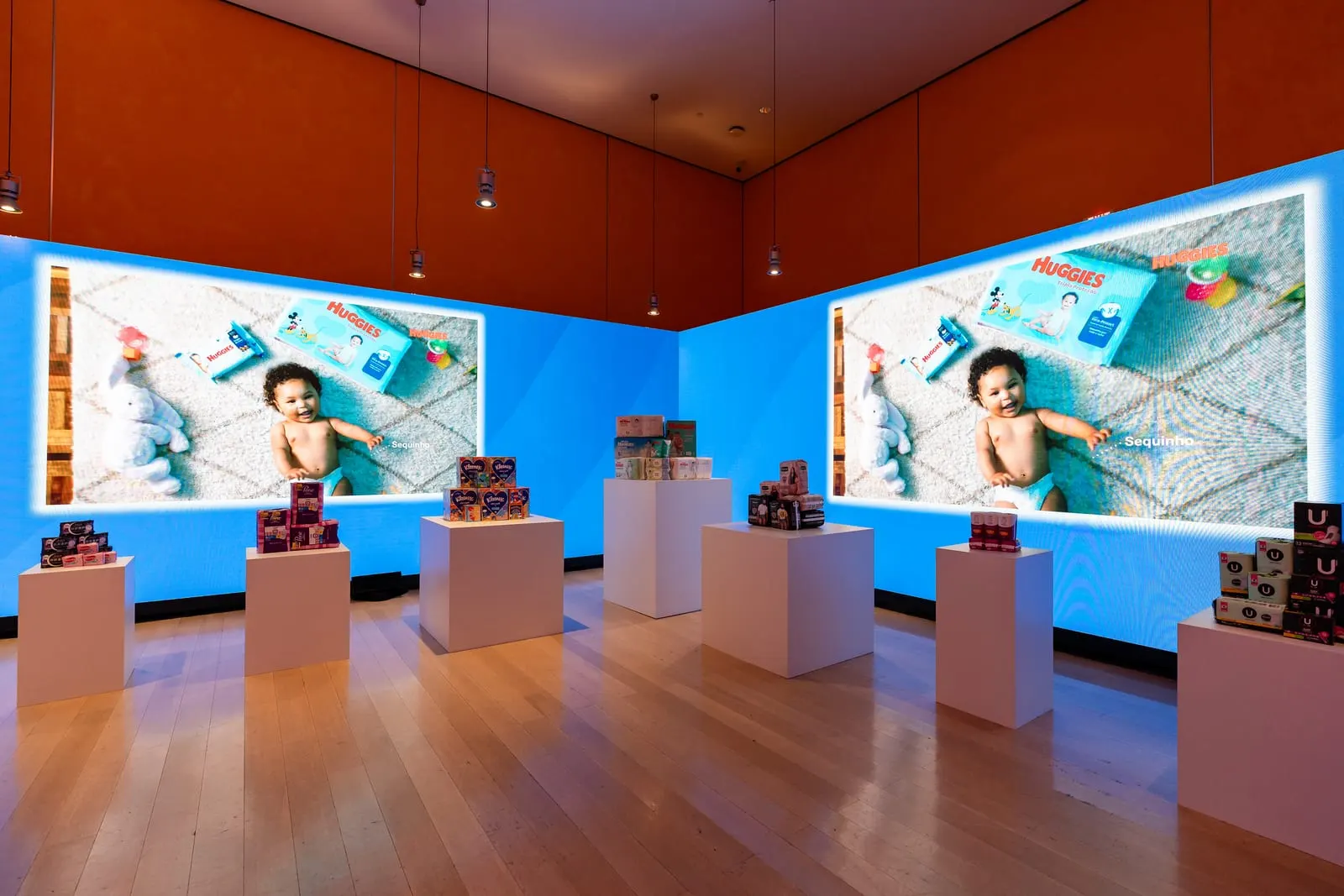 Kimberly-Clark product gallery with Huggies imagery on floor-to-ceiling screens