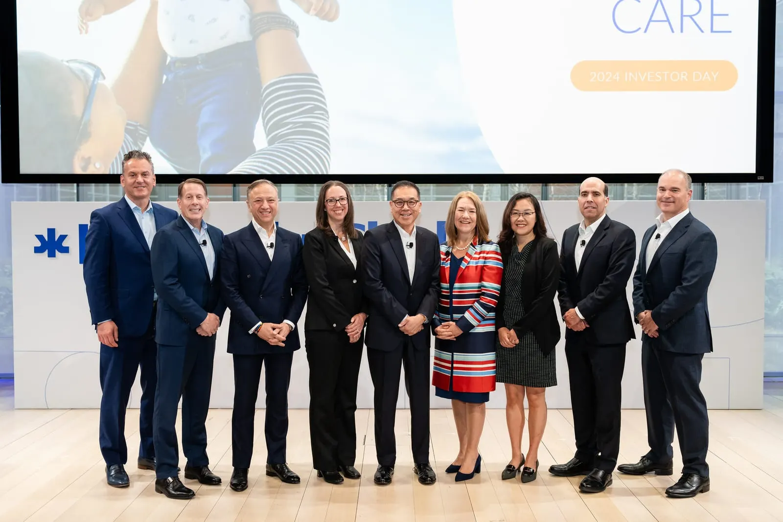 Kimberly-Clark leadership team portrait under the Powering Care screen