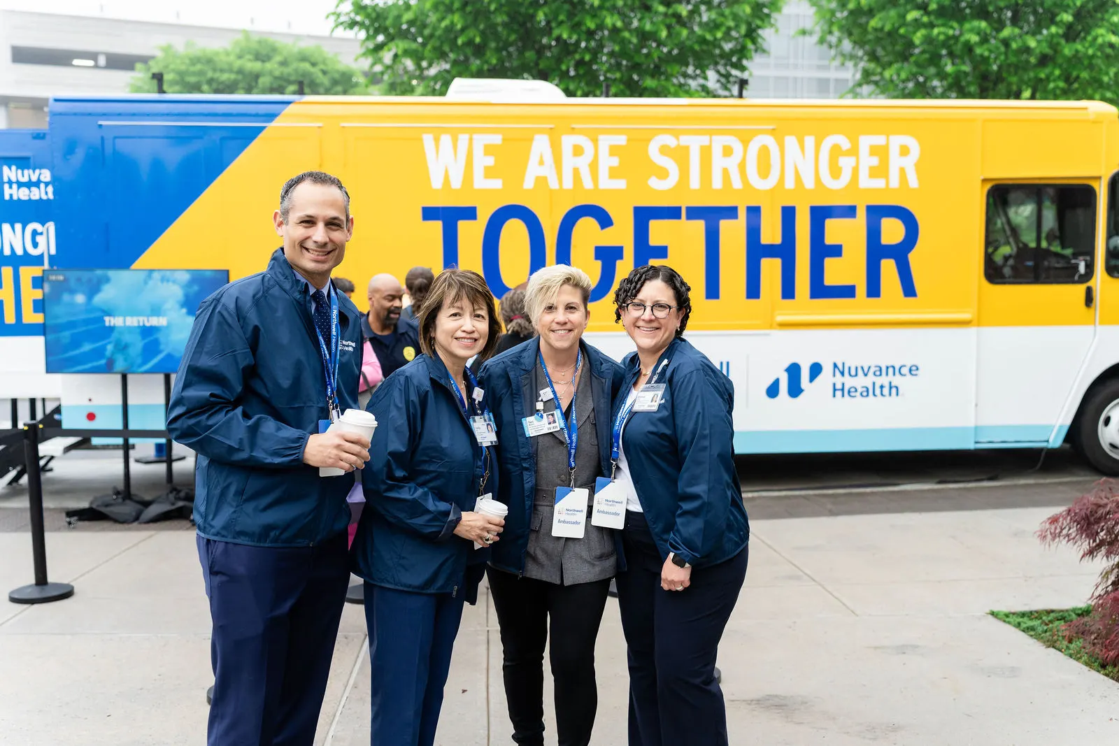 Hospital staff smiling together in front of the We Are Stronger Together truck at Danbury Hospital